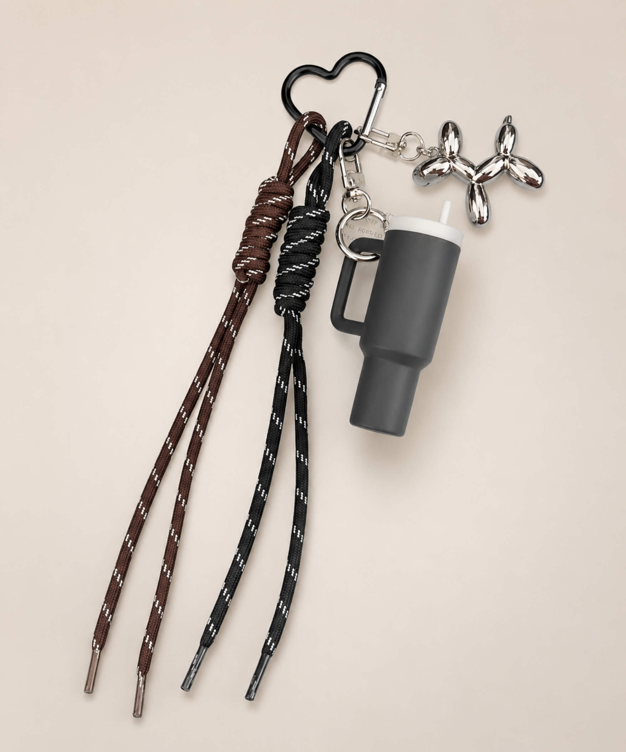 Black tumbler cup rope keychain with heart carabiner, rope straps and balloon dog charm